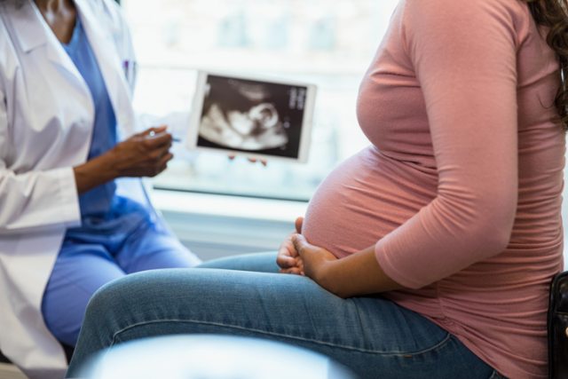 Doctor shares ultrasound image with pregnant patient
