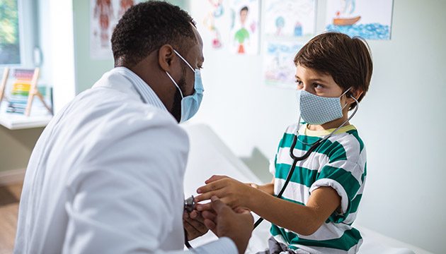 Doctor examines hand of young boy