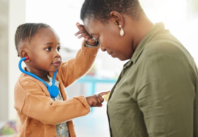 Young child touches woman's heart and head