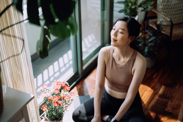 woman sitting on the floor doing a meditation