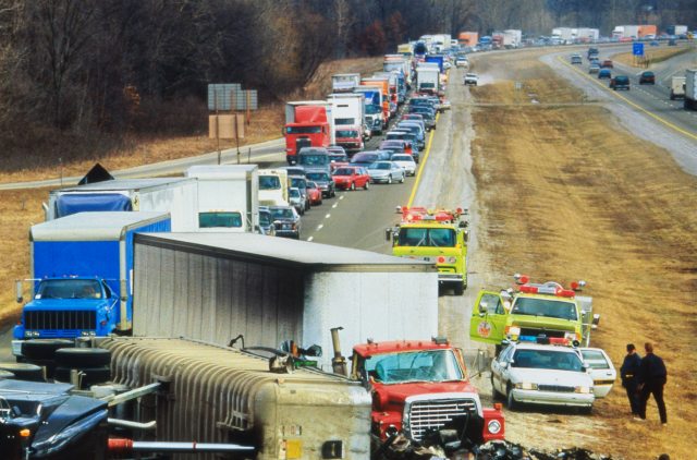 Large collision on freeway with many vehicles backed up