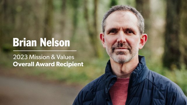 Brian Nelson outside on a trail in a forest