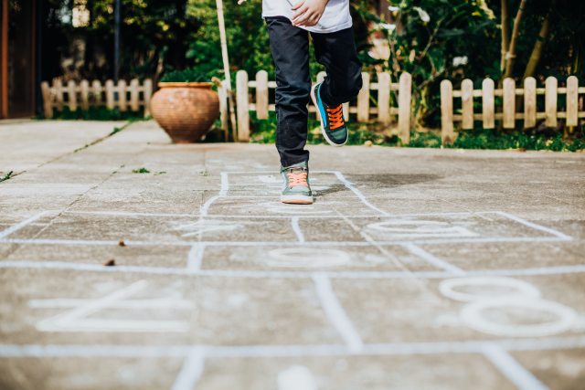 Kid playing hop scotch