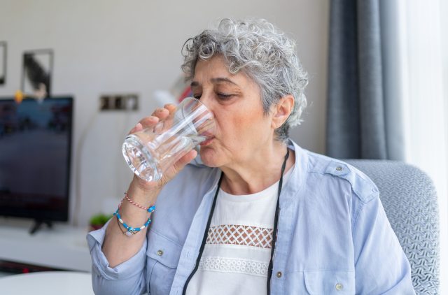 Older woman drinking water