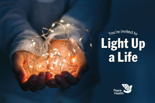 A pair of hands holding a ball of lights