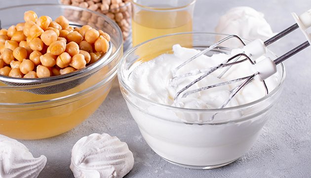 bowl of garbanzo beans, merengue pucks and whipped aquafaba