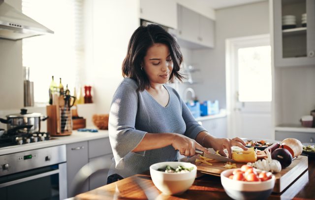 Woman making a healthy meal in her kitchen.