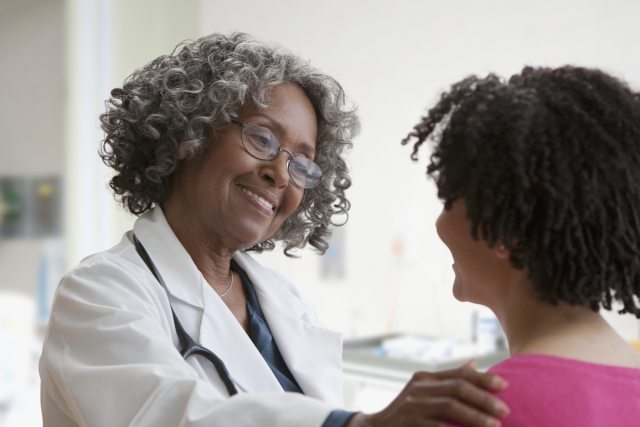 Female doctor talking with female patient.