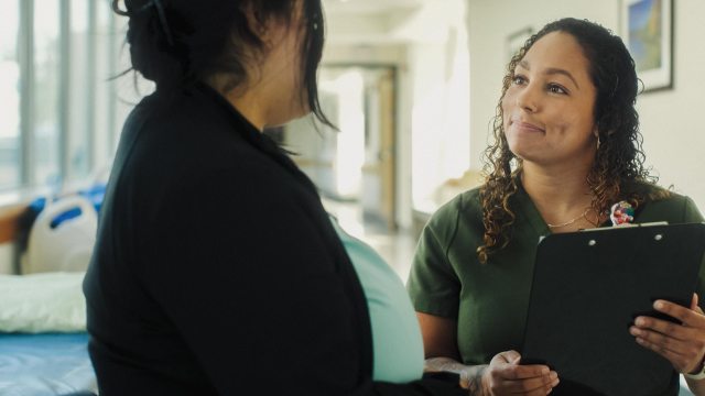 A PeaceHealth St. Joseph Nurse speaks with a colleague