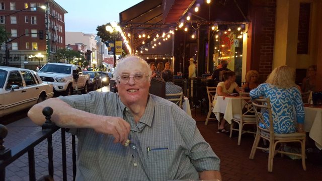 Photo of Craig Bill Adams outside on a patio with in the city