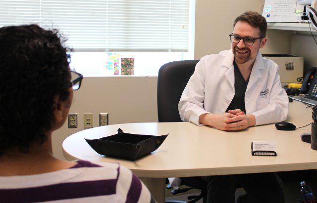 Dr. Matthew Gust speaking with a patient