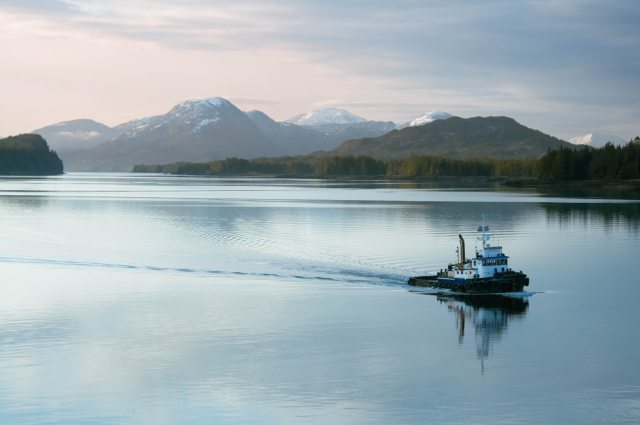 Small tugboat crossing calm water in Ketchikan, Alaska 