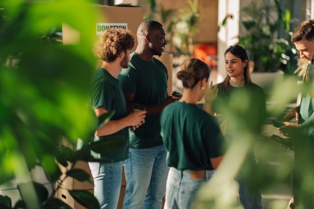 Volunteers gather at a workstation