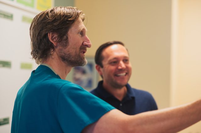Two caregivers smile and have a discussion