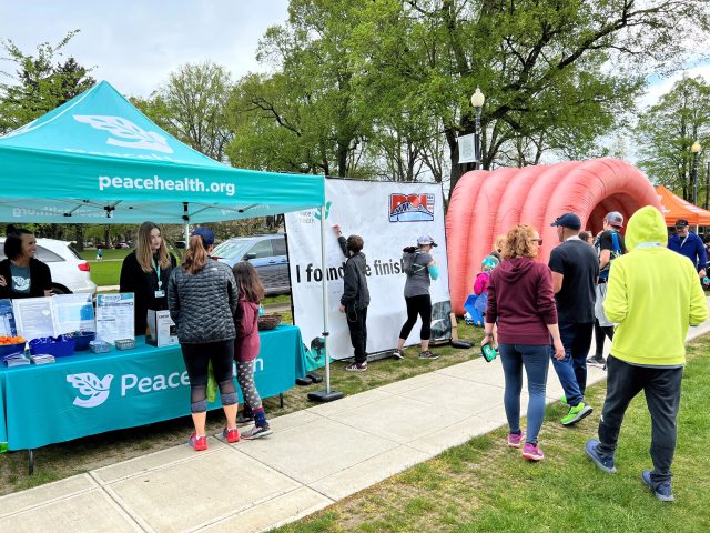 Volunteers and participants gather at a PeaceHealth community event