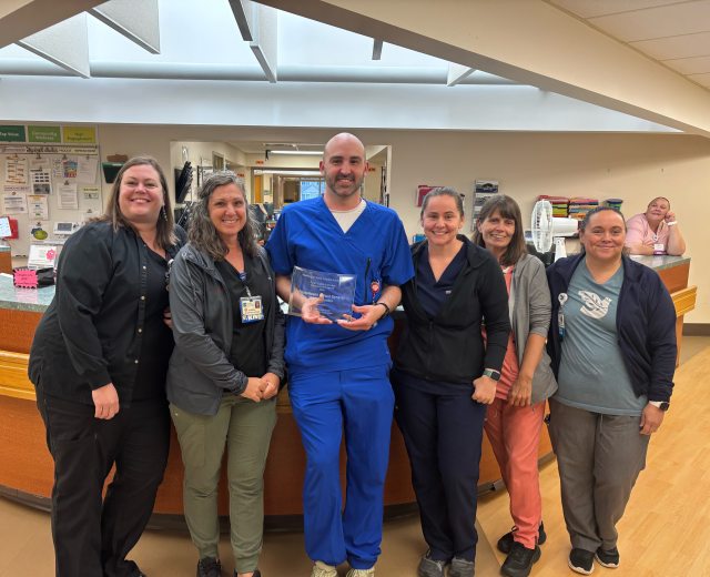 Caregivers at United General Medical Center pose with the WSHA Award at the front reception desk of the hospital