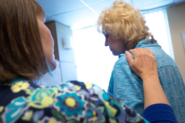 Nurse providing comfort to a female patient