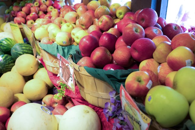 Fruit stand full of apples in baskets