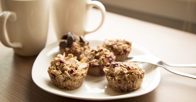 Baked oatmeal cups on a white plate with coffee