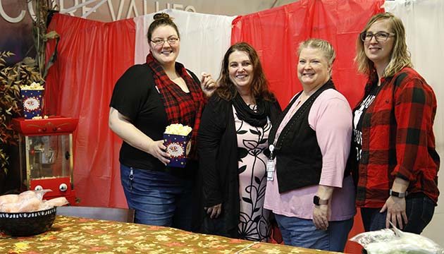 members of PeaceHealth's patient financial service team pose in front of Patti's Pumpkin Patch booth