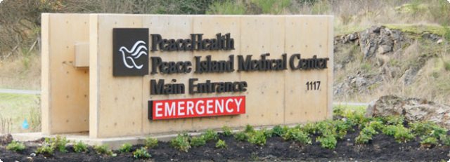 Roadside sign delineating Peace Island Medical Center Emergency Entrance