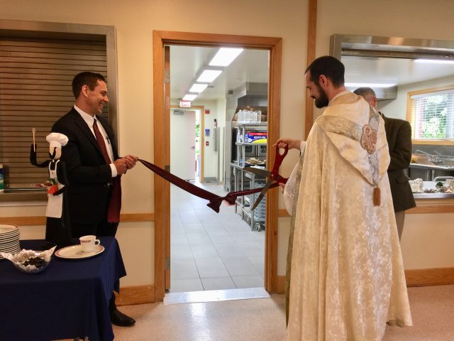 Todd Salnas and Fr. Mark Bentz in ribbon cutting ceremony