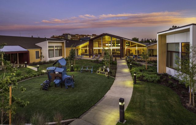 Sunset photo of the Heartfelt House exterior, pathway and grounds