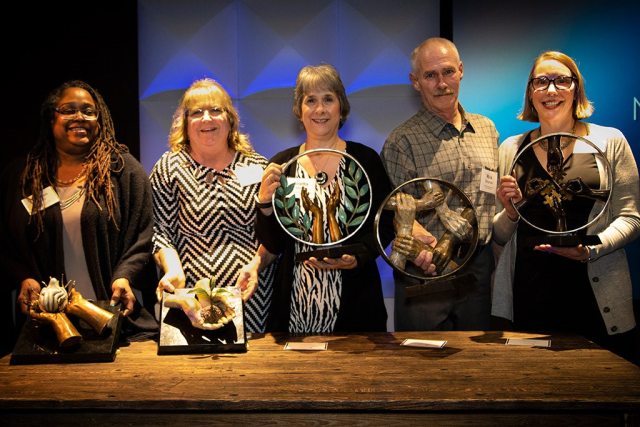 Group photo of Mission & Value Award Winners with their awards