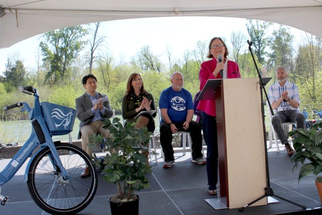 Mayor Lucy at a podium speaks about the PeaceHealth Rides program