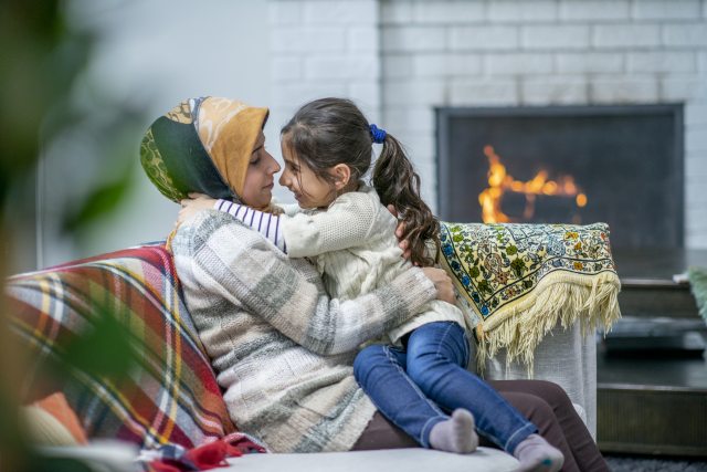 Mother and daughter by the fireplace