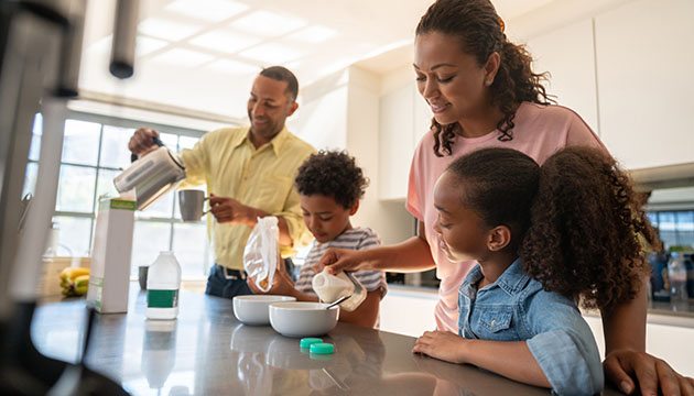 Two children and two adults at breakfast counter