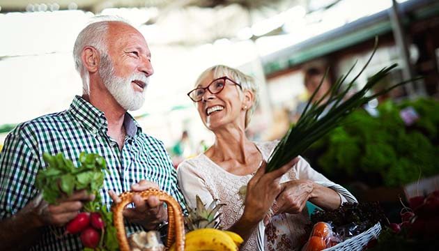 man and woman shop for fresh produce