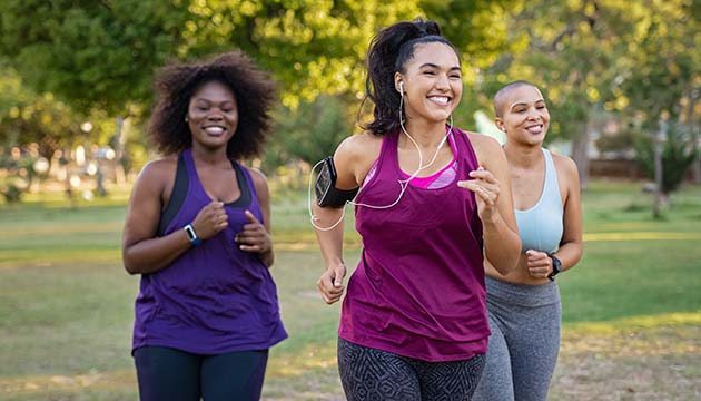 group of three women running outside