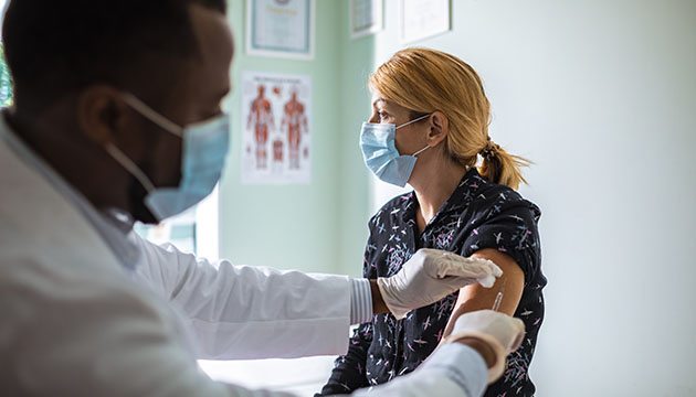 Doctor gives a shot to a woman