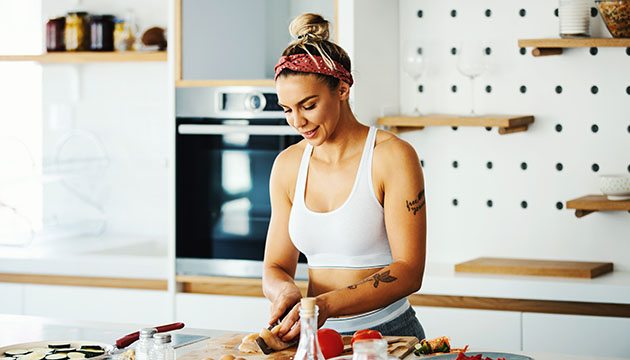 Woman fixing food at kitchen counter