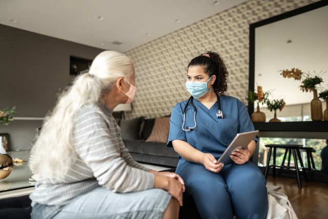 Woman speaking with caregiver