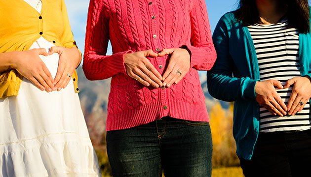 heart hands on pregnant bellies