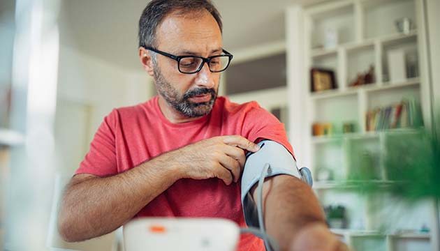 man checking blood pressure
