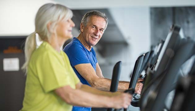couple walking on treadmills