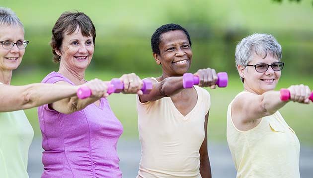 group of women working out with weights