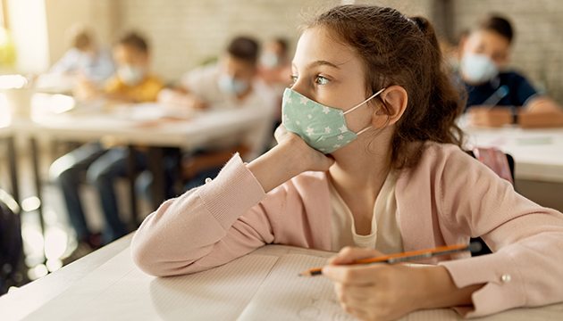 School girl stares into space