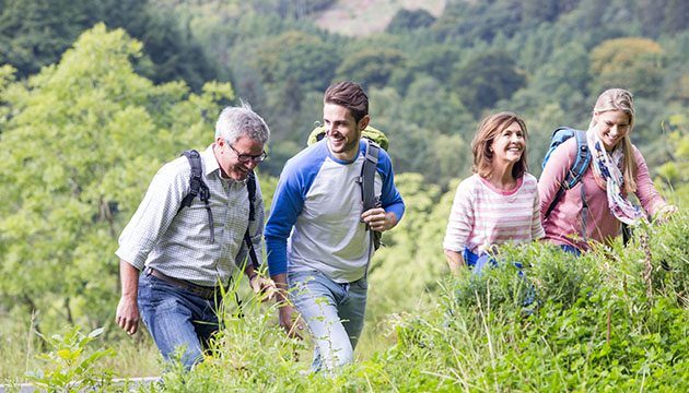 Family of adults hiking in the summer