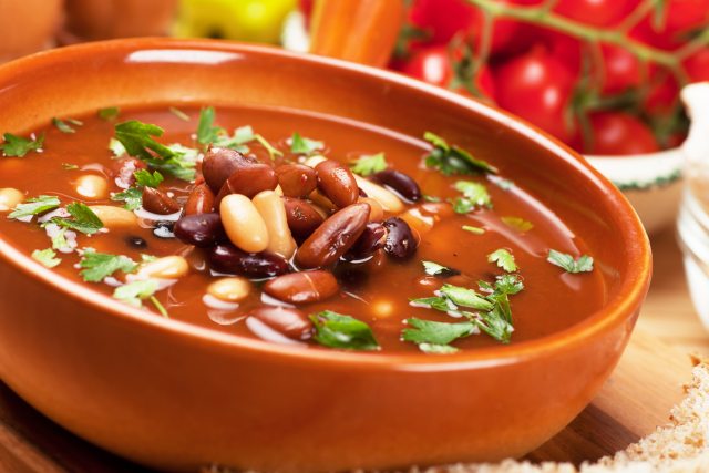 Bowl of chili soup garnished with cilantro