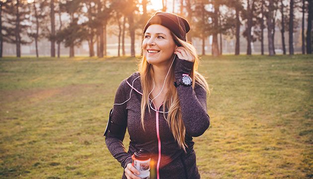 young woman stopping to rest from exercising outside in winter