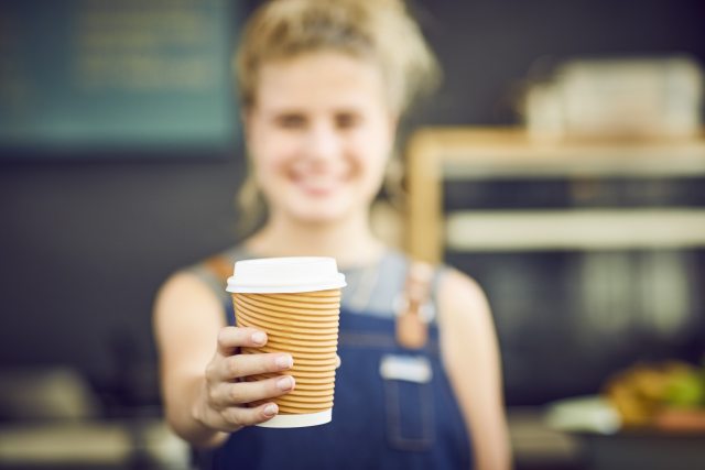 Barista handing a drink in first person view