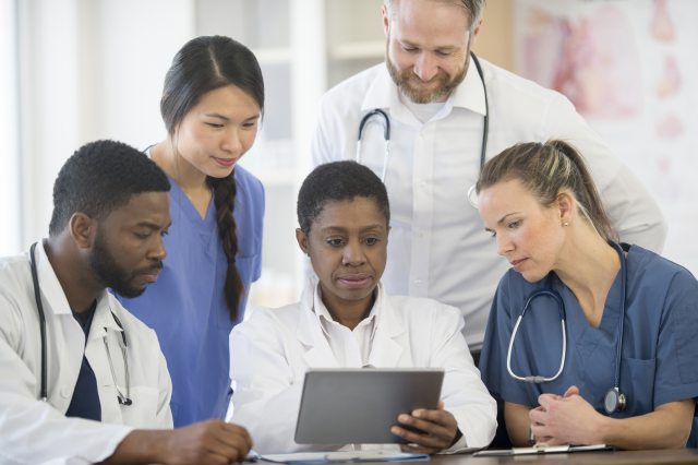 A group of providers reading a chart