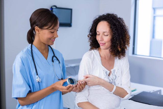 A healthcare provider checks a patient's blood oxygen levels