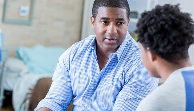 Two people talking in a patient room