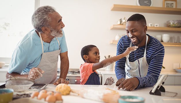 Three generations of men baking in the kitchen