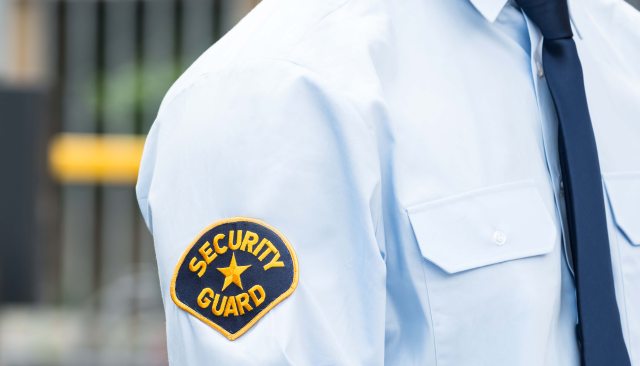 Close-up of patch on security guards shoulder